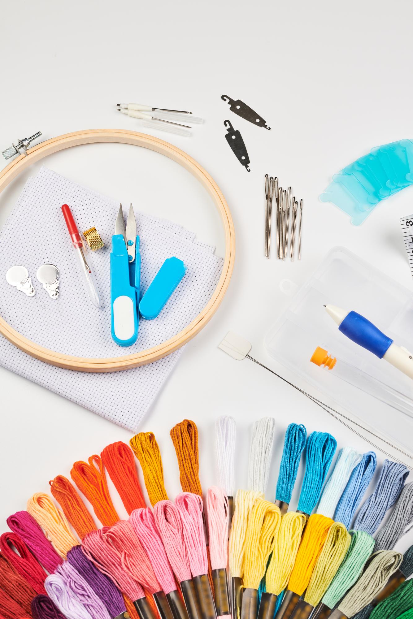 workshop table with threads and embroidered patch